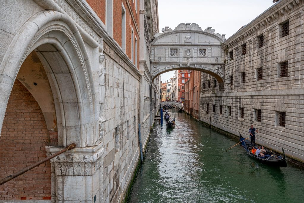 Photo of the Bridge of Sighs, with a few gondolas visible in the canal below.