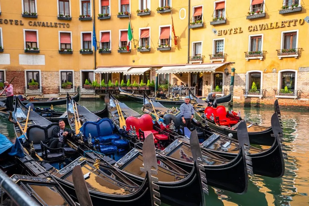 Photo of gondolas parked together near Piazza San Marco in Venice