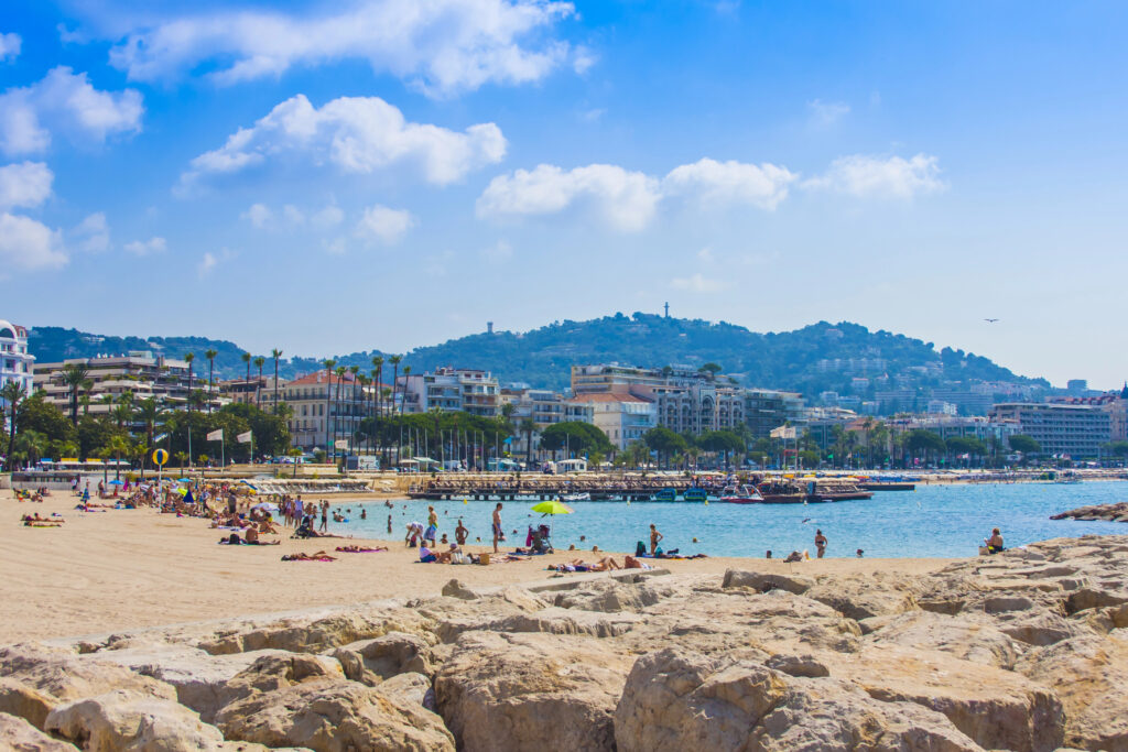 beach in cannes france with hills in the background, one of the best cities in france's south to visit