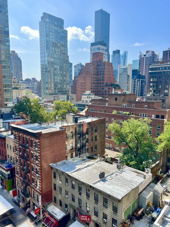 view of midtown nyc skyline as seen from apartment terrace on a sunny day