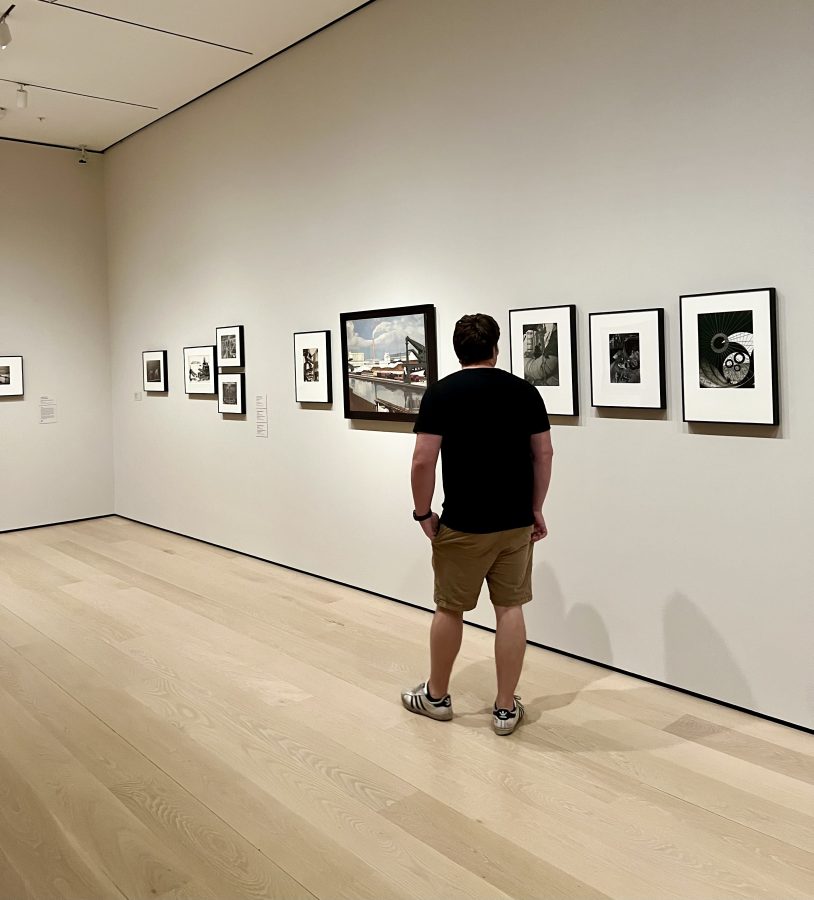 jeremy storm walking through a room of paintings in the museum of modern art, one of the best places to visit in midtown nyc