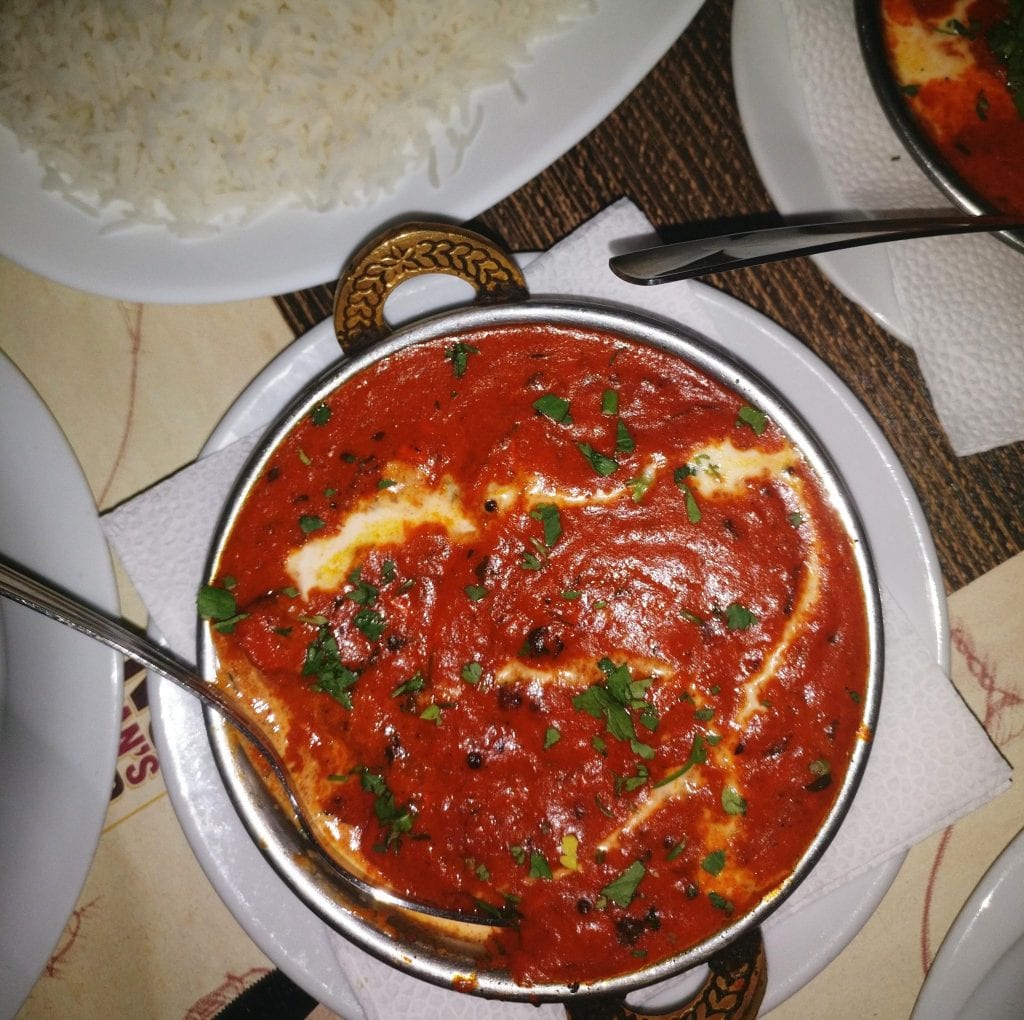 places to visit midtown nyc Photo of a silver bowl of chicken tikka masala taken from above. There's a silver spoon in the bowl.