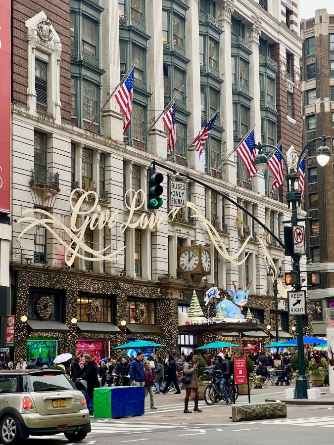 ftont facade of macys at harold square decorated with christmas lights in new york city