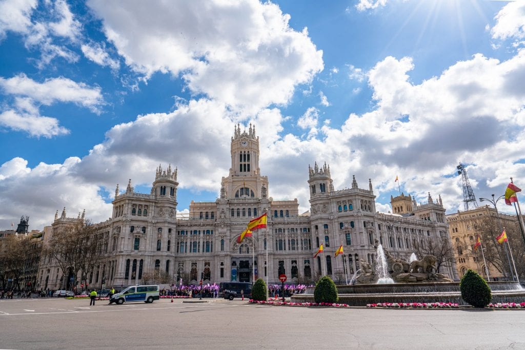 Cybele Palace in Madrid Spain as photographed from across the street. The sky is blue with white clouds. Definitely come by here during your 3 days in Madrid!