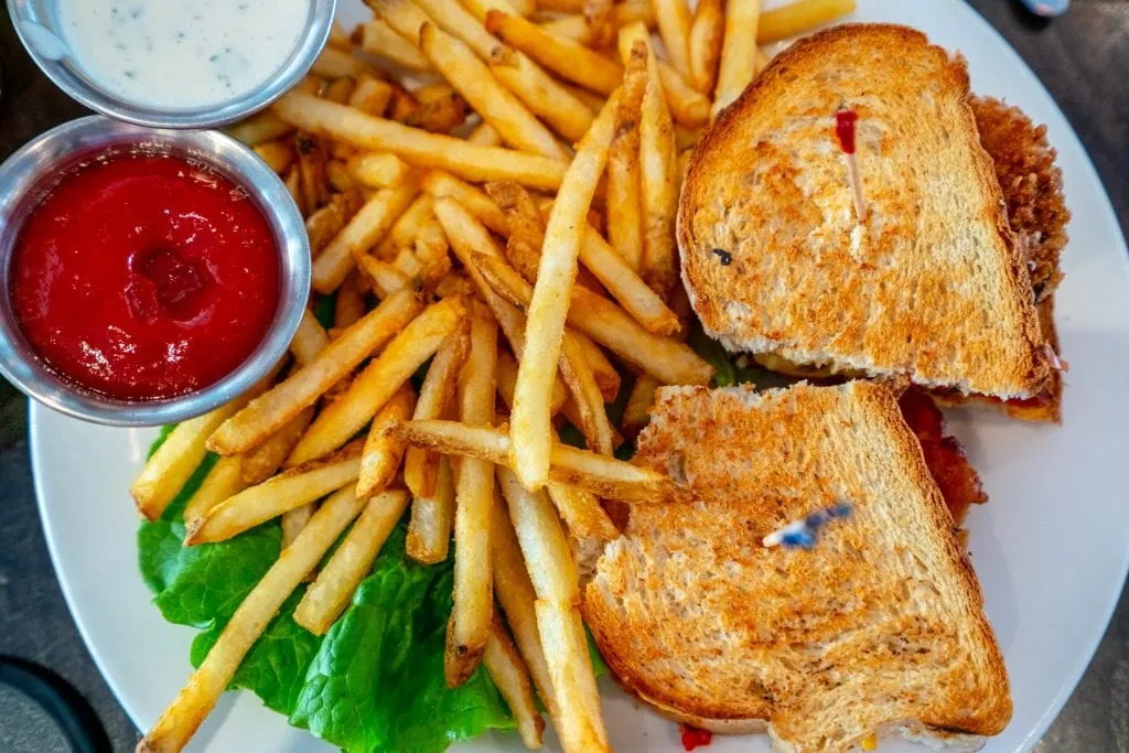 Sandwich and fries shot from above, as served at Front Porch Cafe on Ocean Drive.