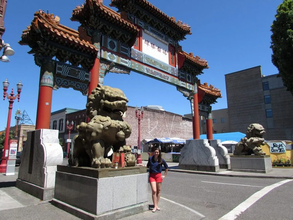 Kate standing in front of gate to Chinatown in Portland, OR