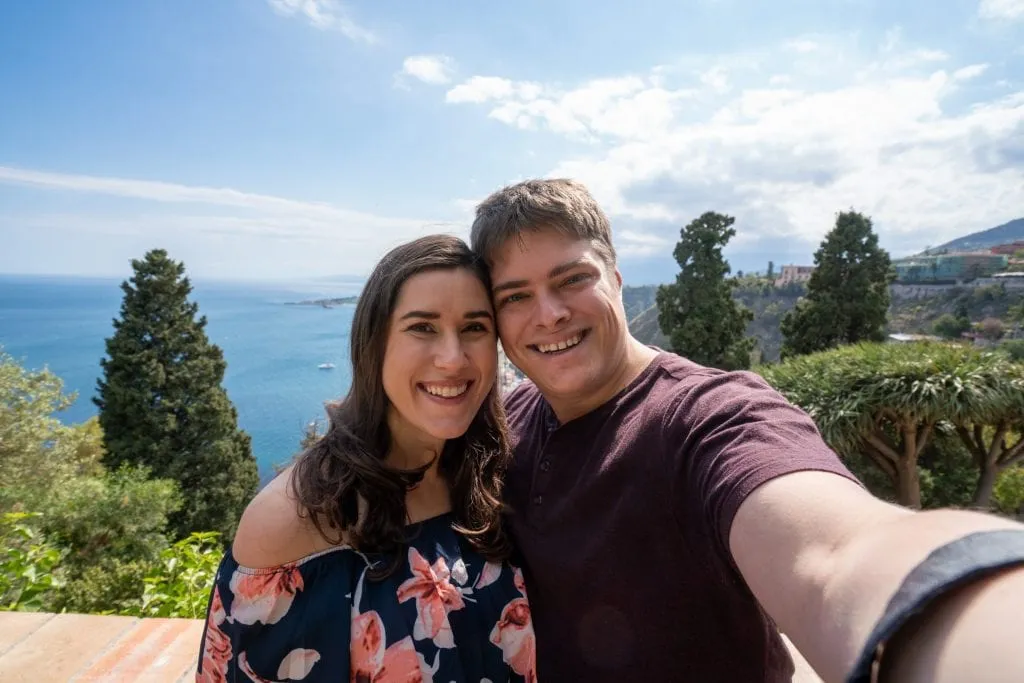 Selfie of Kate and Jeremy in Taormina Sicily. You can see the sea in the background.