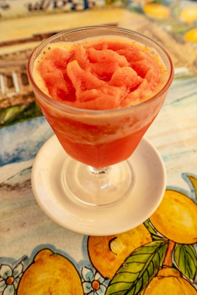 vertical photo of an orange granita served at bambar one of the best places to visit taormina italy