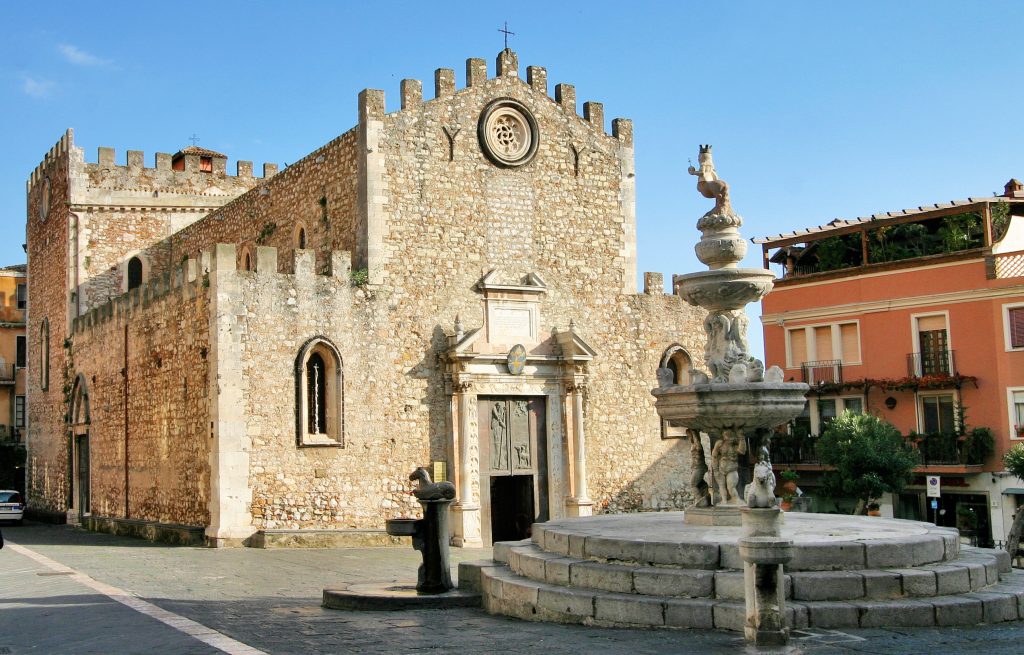 front facade of taormina sicily duomo with fountain in front of it