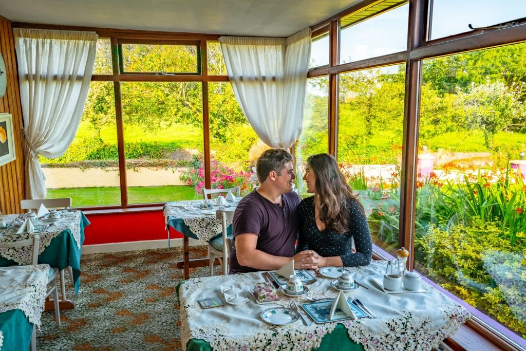 Jeremy Storm and Kate Storm at a breakfast table in Find Us Farmhosue, an excellent bed and breakfast getaway to consider during your Ireland honeymoon!