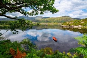Photo of a rowboat in a lake in Killarney National Park Ireland--definitely be prepared for all weather when putting together your Ireland packing list!