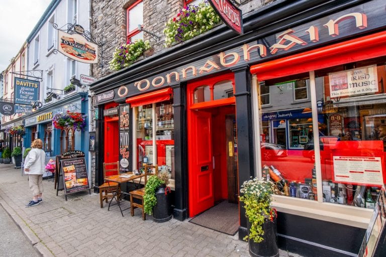 Colorful pub painted red in Kenmare Ireland, one of the prettiest small towns in Ireland