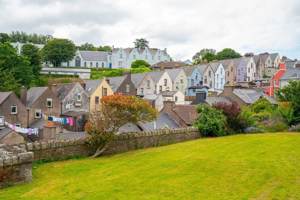 View of the Deck of Cards houses in Cobh Ireland from behind with a green lawn in front of them