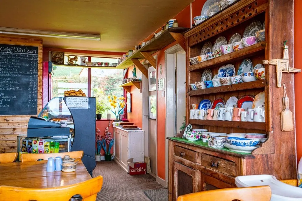 Cozy tearoom in Ireland with a hutch filled with teacups on the right--finding places like this is part of the fun of tracking down what to eat in Ireland