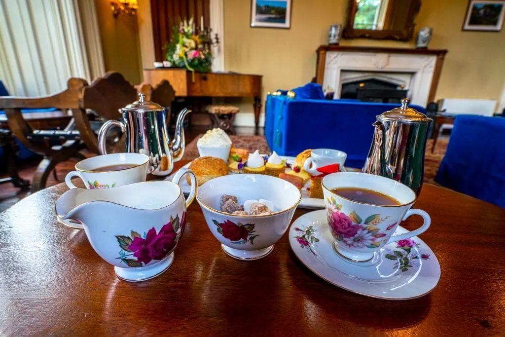 Irish tea set with pink flowers being displayed at Belleek Castle. A beautiful tea set is one of the best Irish souvenirs