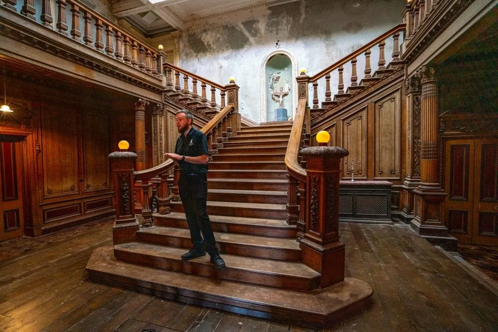 Staircase in Loftus Hall with tour guide standing on it--for independent travelers, this is part of one of the best day trips from Dublin Ireland!