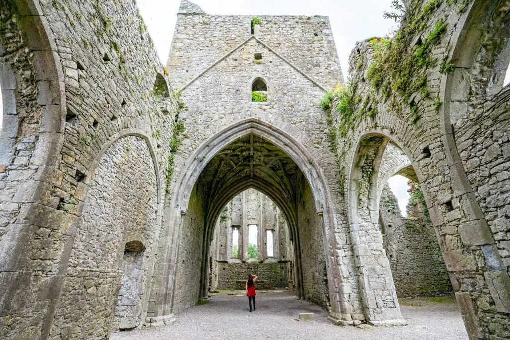 Kate Storm in the distance walking into Hore Abbey--this dress and tights combo is one of my go-to outfits when packing for Ireland.