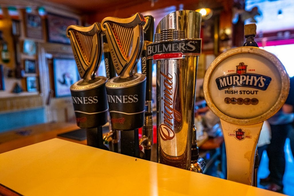 Collection of beer pulls with beer on top in a pub in Ireland