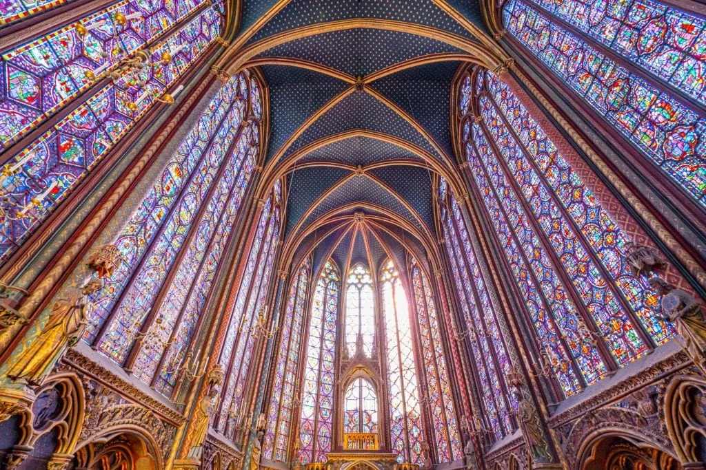 Interior of the stained glass of Sainte-Chapelle when looking up from the altar, one of the prettiest places to photograph in Paris France