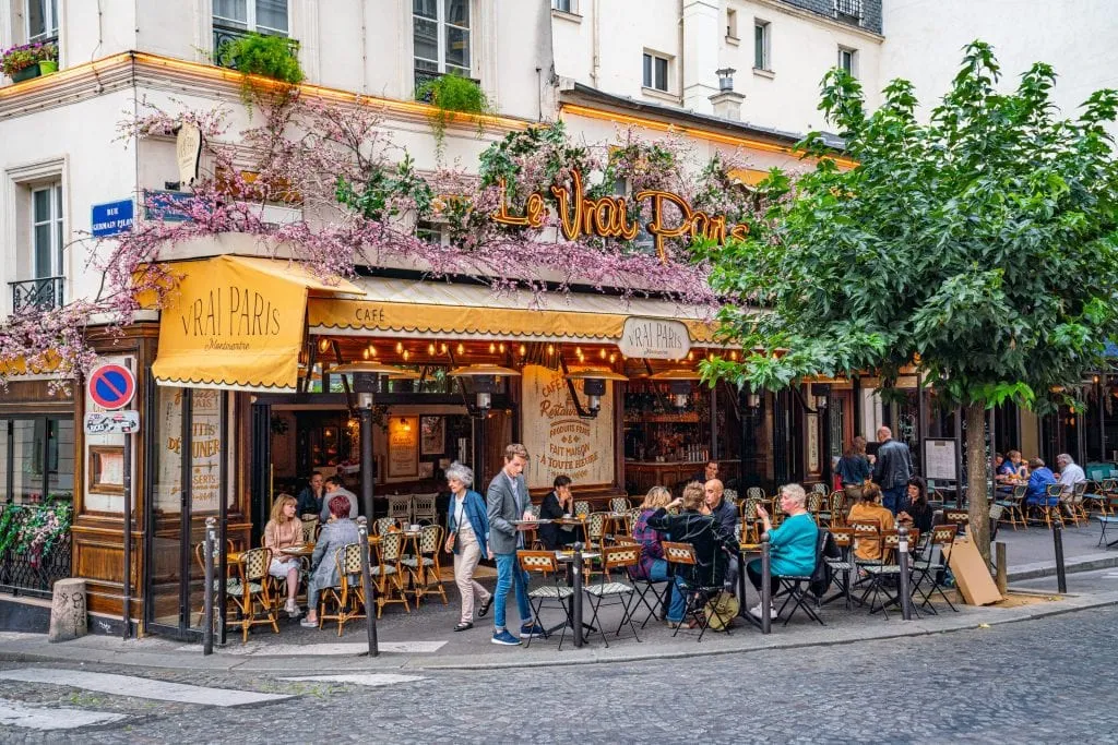 Photo of a colorful cafe in Paris France--any weekend in Paris trip will include plenty of time in cafes!