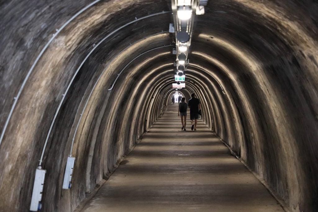 two people walking through concrete gric tunnel during a visit zagreb croatia