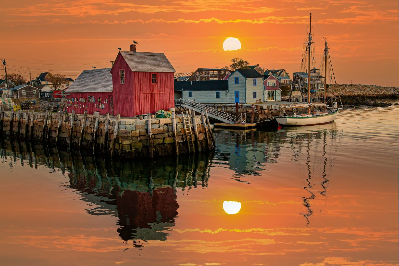 sunset over motif no. 1 in rockport, one of the best weekend getaways in new england