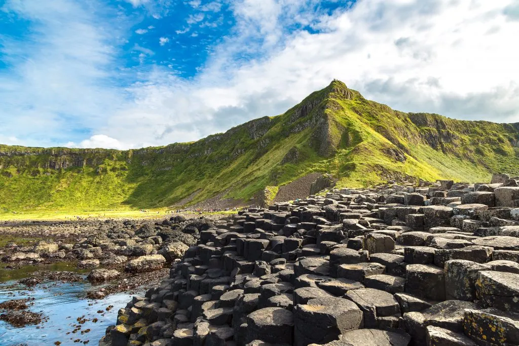 giants causeway in northern ireland on a sunny day looking toward the island