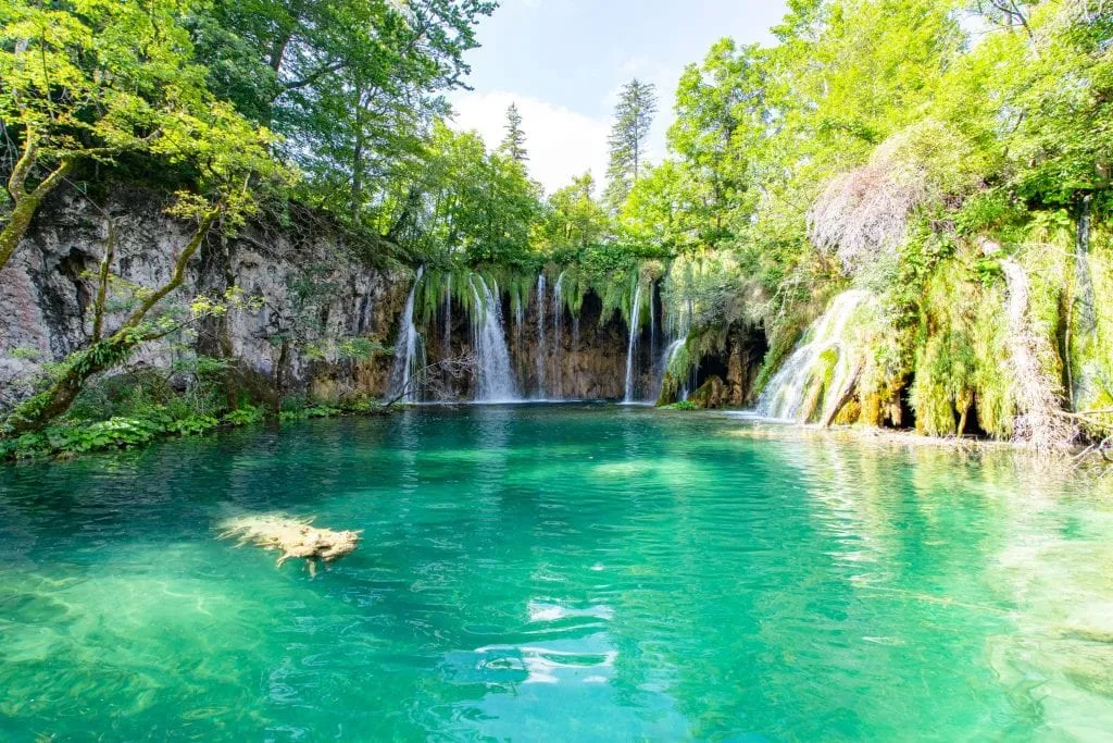 Turquoise lake with small waterfalls as seen in Plitvice Lakes National Park Croatia, an important part of any 10 day Croatia itinerary!