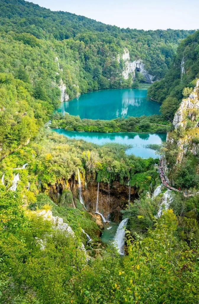 Postcard view of Plitvice Lakes Croatia showing lake and waterfalls seen from above in a vertical image