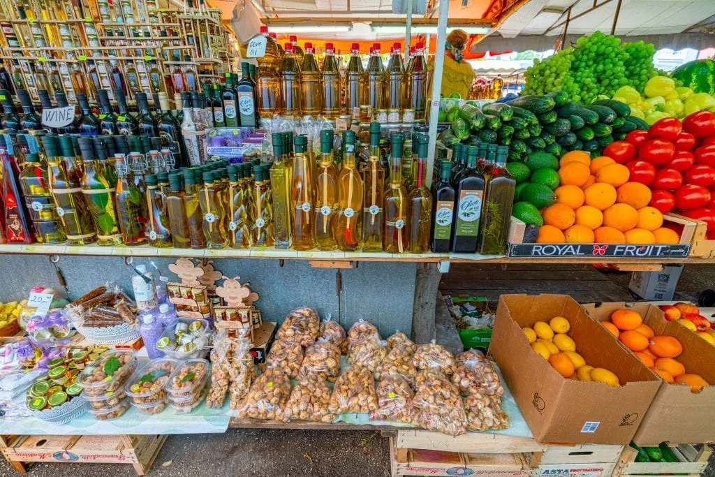 market stall in croatia with fresh fruits and olive oils