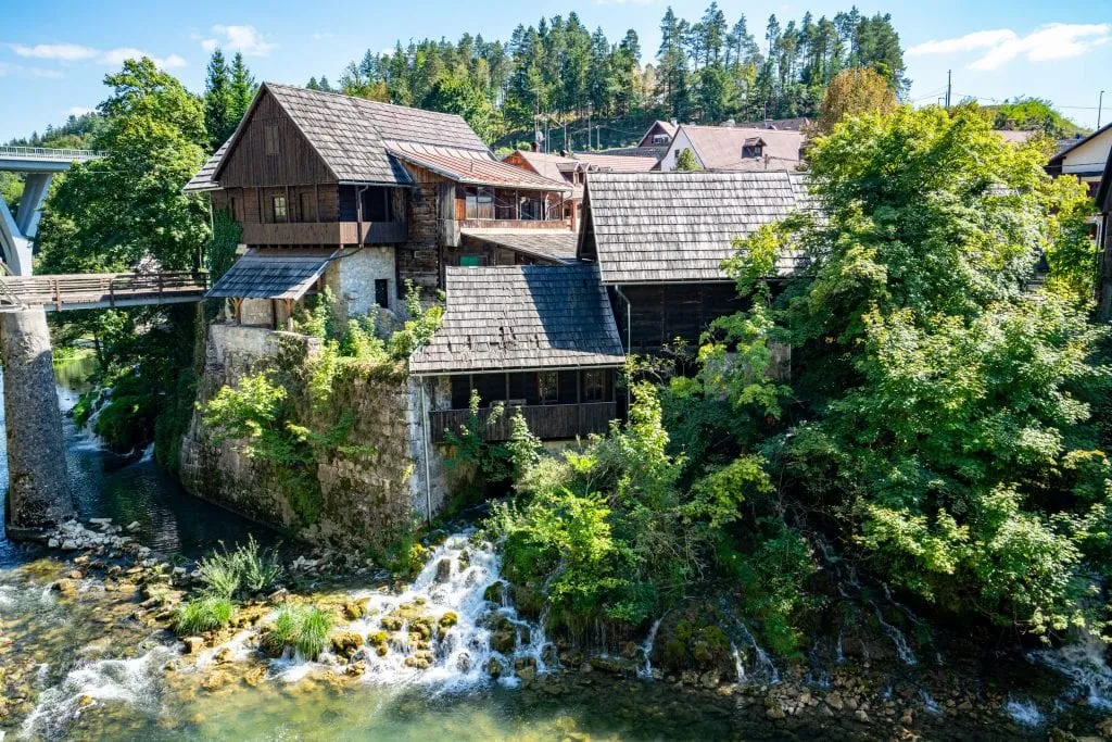 traditional wooden home of rastoke croatia with waterfall under it, one of the most beautiful places to visit in croatia