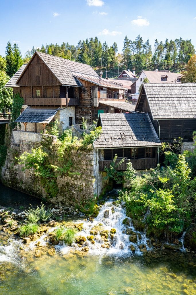 Rastoke Croatia wooden house with old mill in front and waterfalls running under it