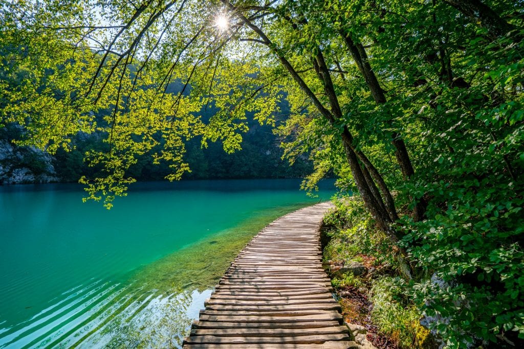 Path made of wooden planks in Plitvice Lakes National Park that is built over a turquoise lake