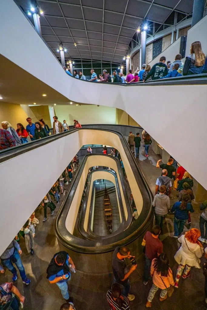 Lines of people visiting the Vatican Museums climbing a spiral staircase to reach the exhibits