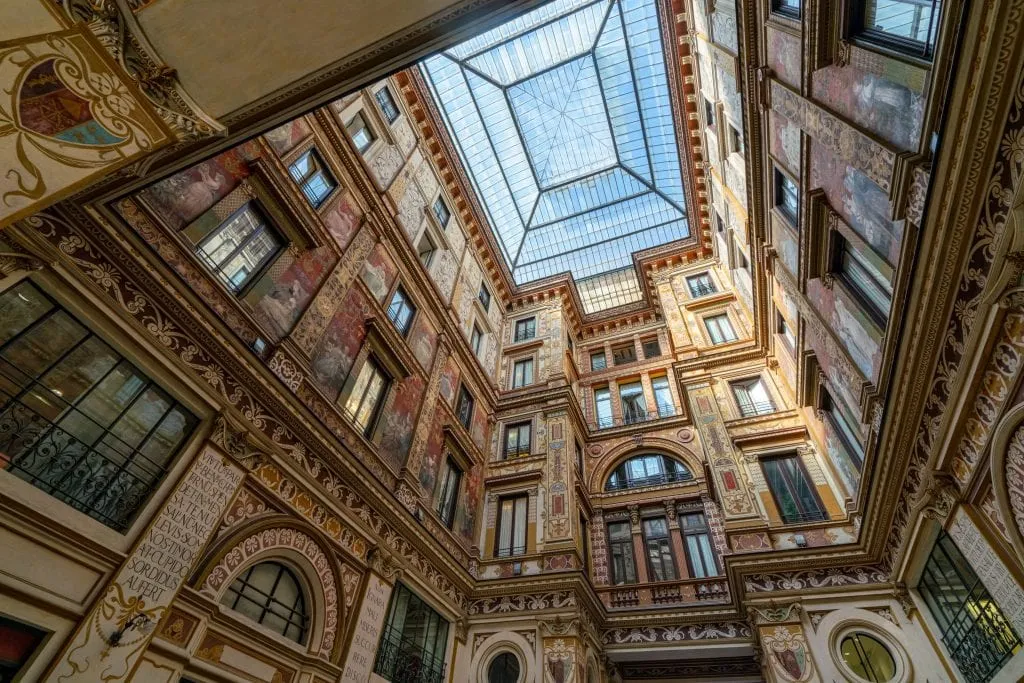 Photo of Galleria Sciarra Rome looking up, showing the vaulted glass ceiling in the center
