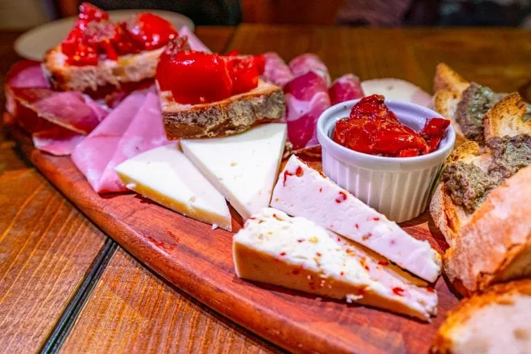 meat and cheese plate served in restaurant italy coperto