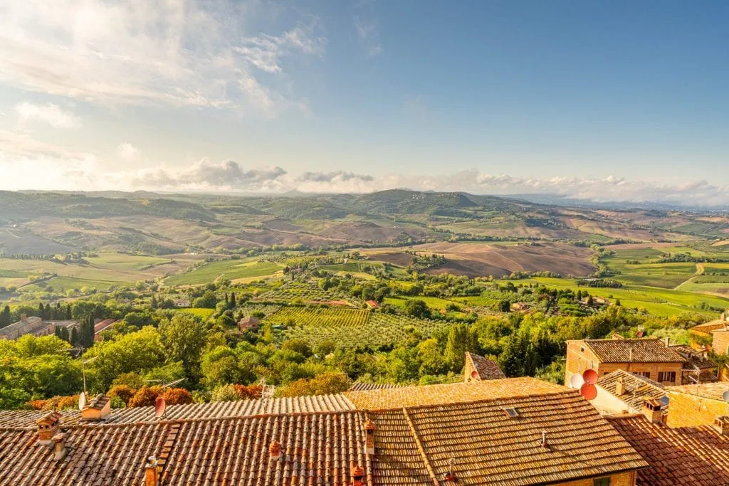 Tuscan countryside as seen from Montepulciano, with the countyside bathed in golden light--this Tuscany travel blog post will cover everything you need to know about finding spots like this during your Tuscany road trip!