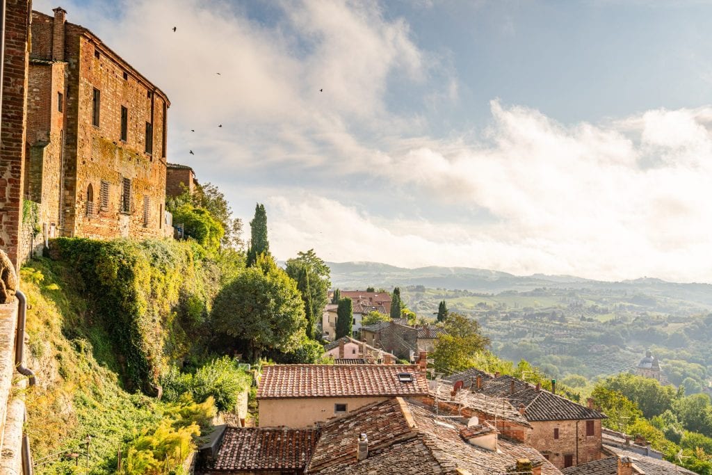 View of the Tuscan countryside from Montepulciano with the village on the left, one of the best stops when driving from Rome to Florence road trip