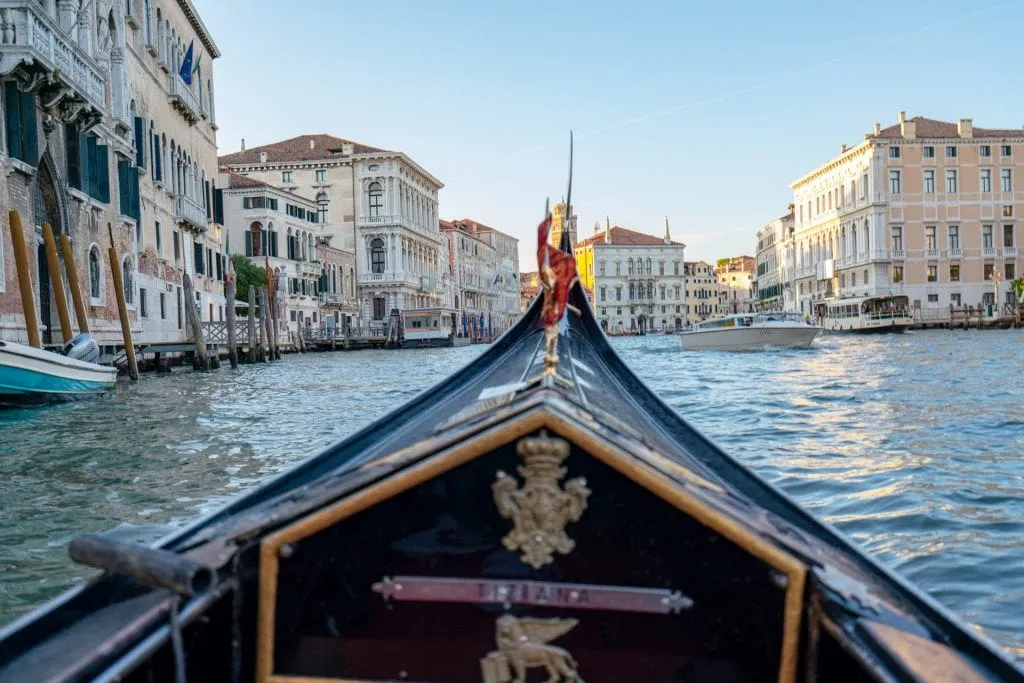 Front of a gondola shot close up with the Grand Canal in the background--a gondola ride is an excellent addition to your Florence to Venice day trip!