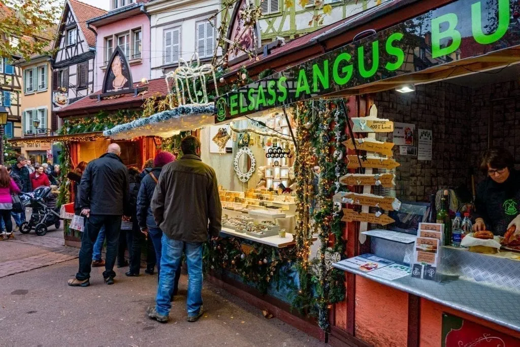 People shopping at a Christmas market in Colmar France
