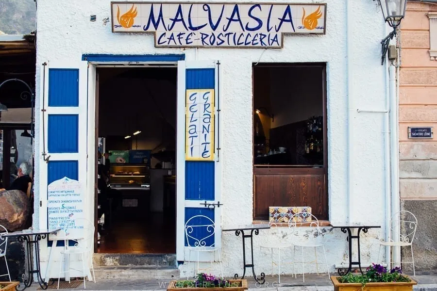 White and blue storefront in Malfa Sicily, one of the prettiest small towns in Italy