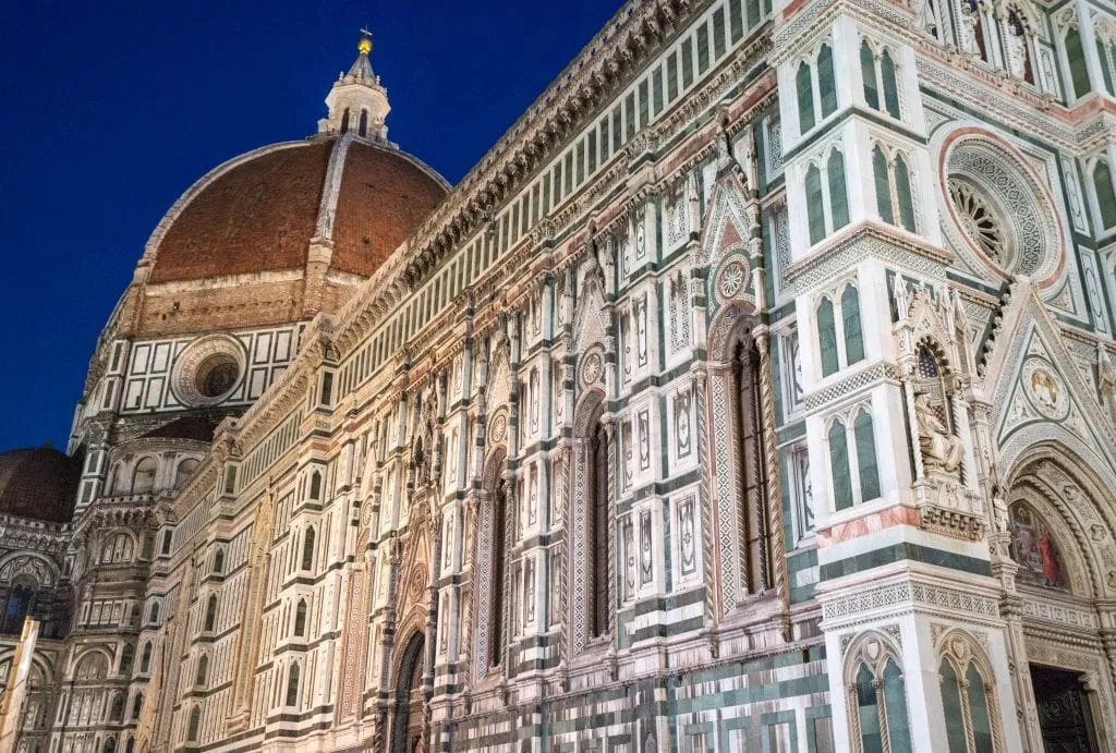 Photo of the side of Florence's Duomo at blue hour with cupola in the background. Checking out the Duomo is one of the best things to do in Florence at night