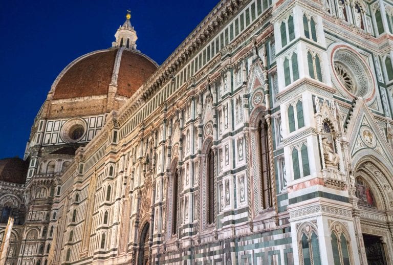 Photo of the side of Florence's Duomo at blue hour with cupola in the background. Checking out the Duomo is one of the best things to do in Florence at night