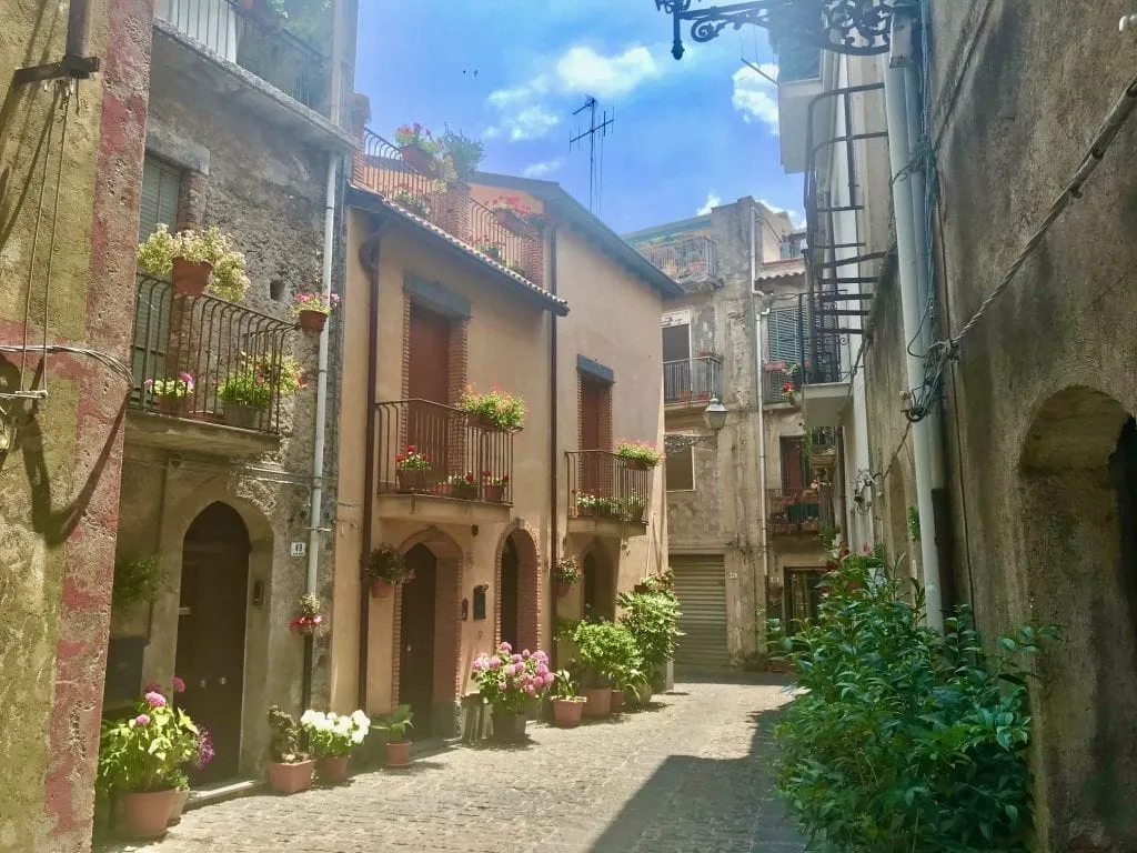 Small street in Randazzo Italy lined with stone buildings on both sides