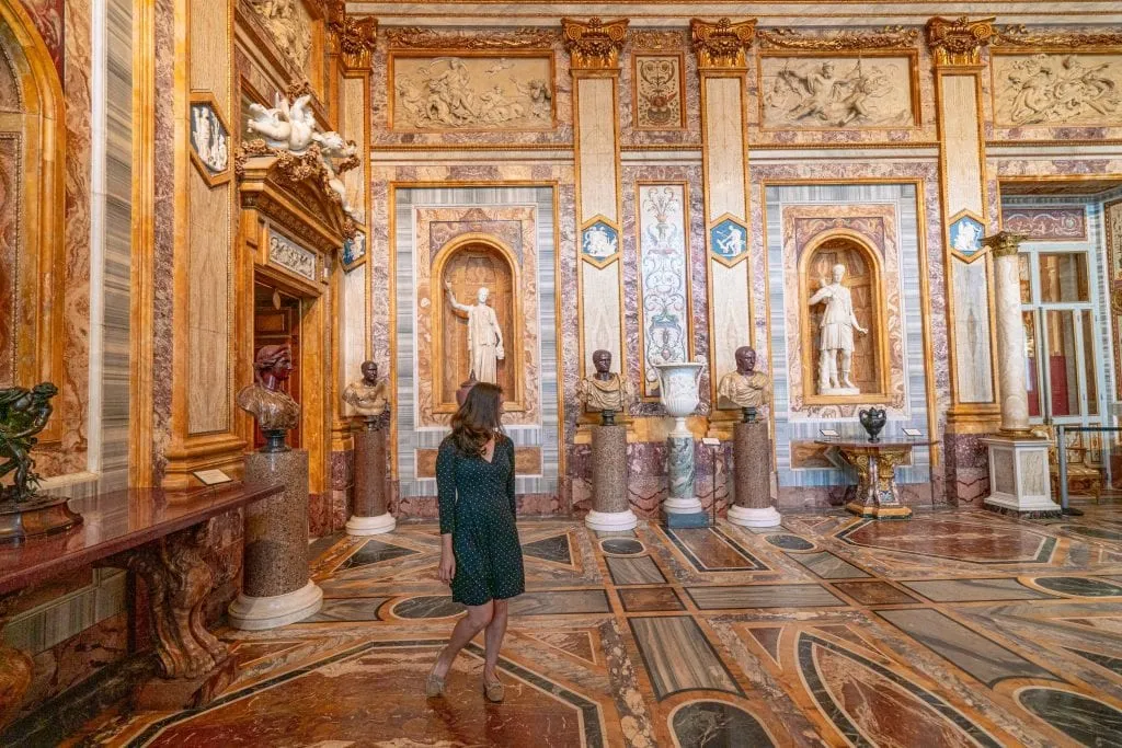 Kate Storm in a gray dress looking away from the camera in the Galleria Borghese--this dress is a great example of what to wear in Rome Italy