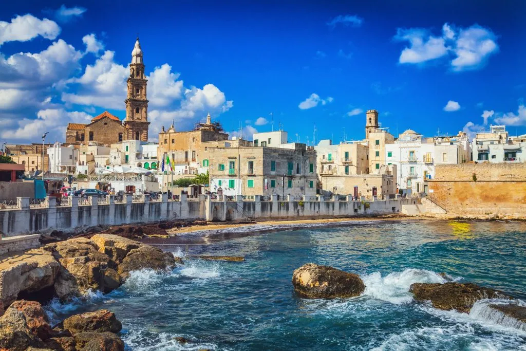 whitewashed town of monopoli italy as seen from across the water, one of the best villages in italy to visit