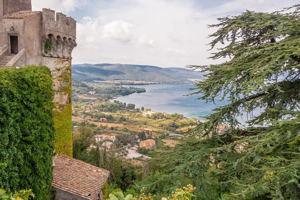 lake bracciano from above with castle turret in the left foreground