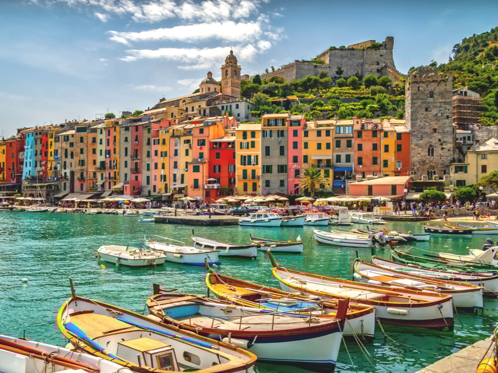 harbor of porto venere italy with boats in the foreground, one of the best small villages in italy