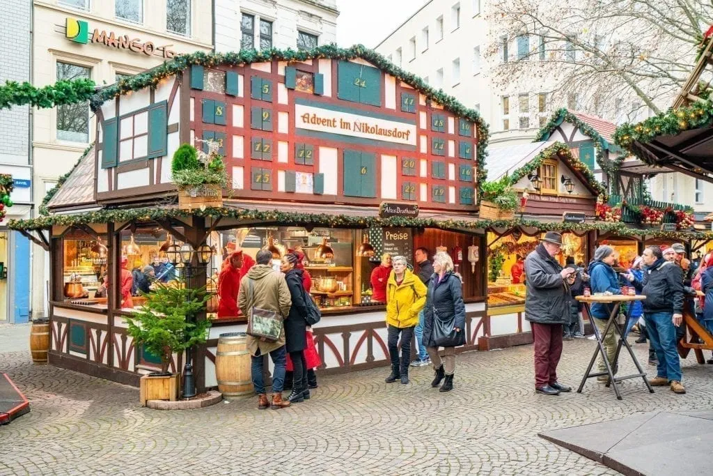 people shopping for gifts at christmas market stalls in cologne germany