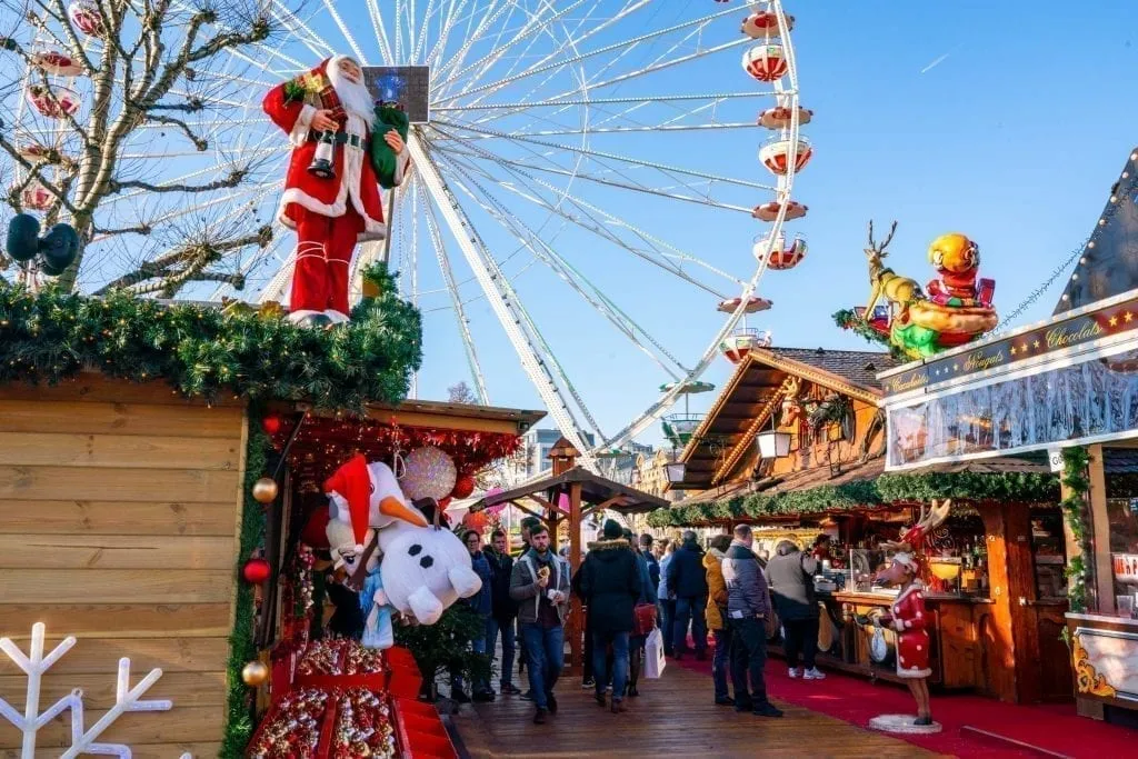 christmas market stalls in luxembourg with ferris wheel in the background, as seen during a europe christmas trip